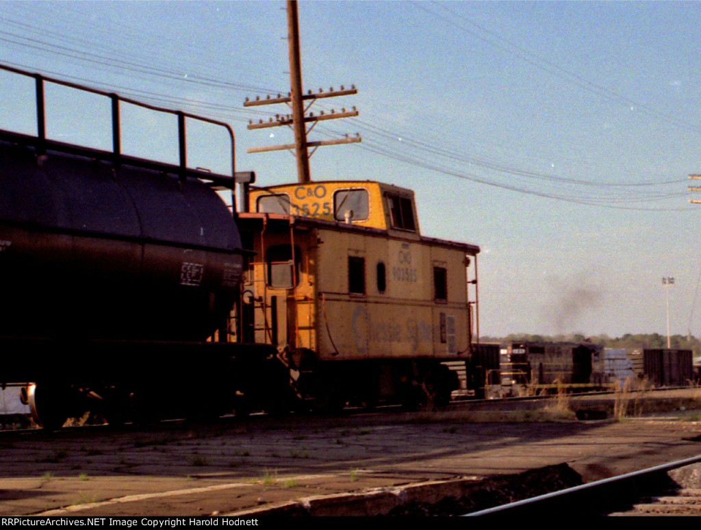 CO 903525 brings up the rear of a southbound train while SBD 785 works the yard